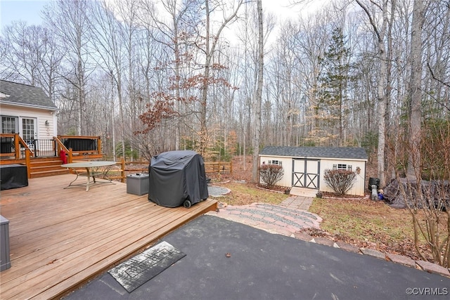 wooden deck featuring area for grilling and a shed