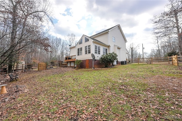 view of home's exterior featuring a yard and central AC