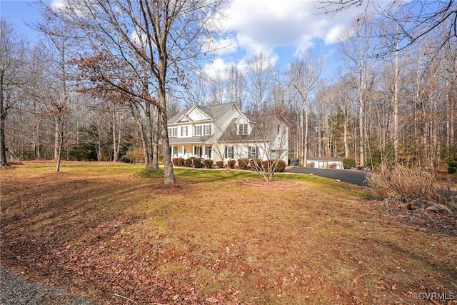 view of front of property with covered porch and a front lawn