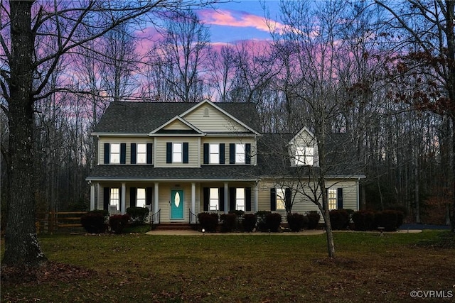 view of front facade with a yard and covered porch