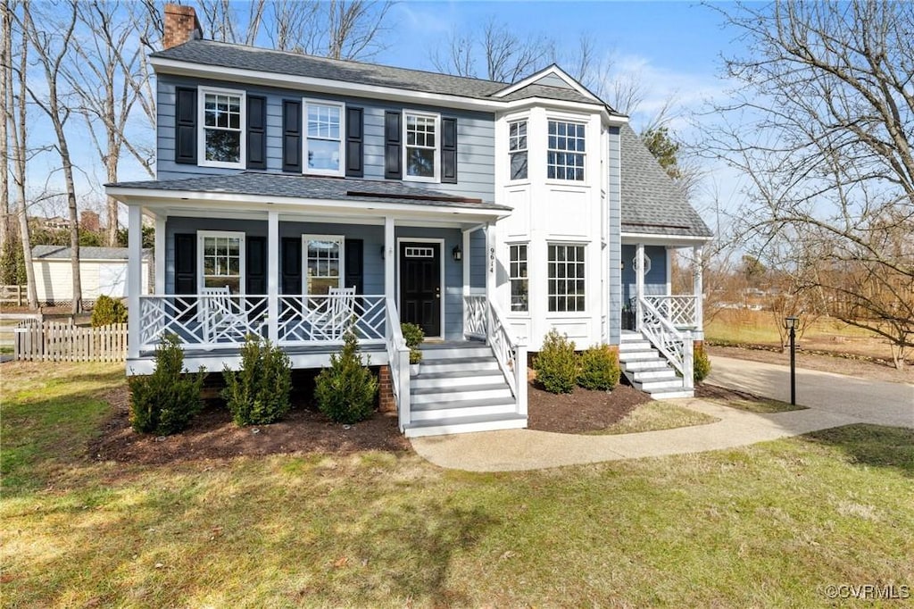 view of front of house featuring covered porch and a front lawn