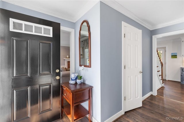 foyer entrance with dark wood-type flooring and ornamental molding