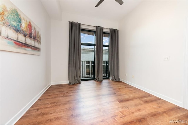 spare room featuring wood-type flooring and ceiling fan