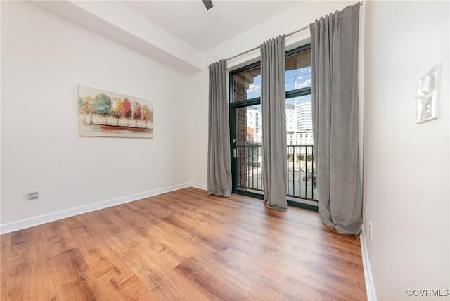 empty room featuring ceiling fan and hardwood / wood-style floors