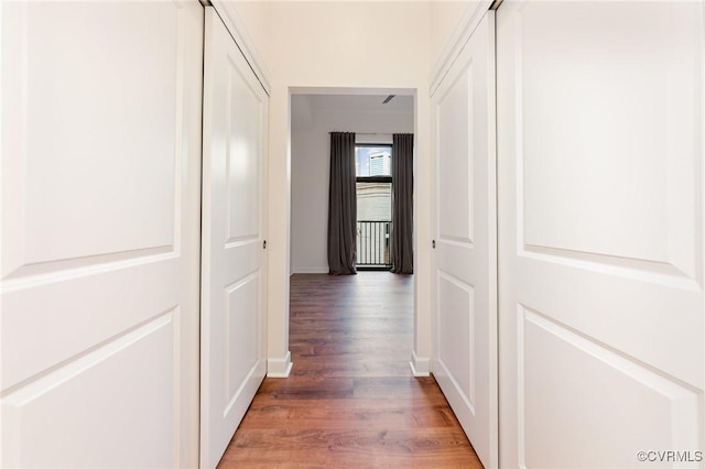 hallway with dark hardwood / wood-style flooring