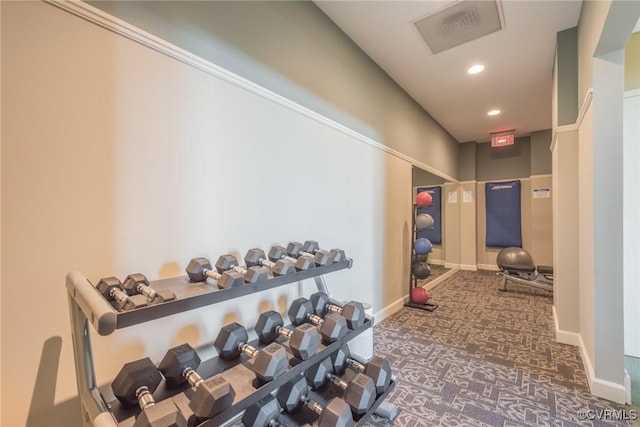 workout room featuring dark colored carpet