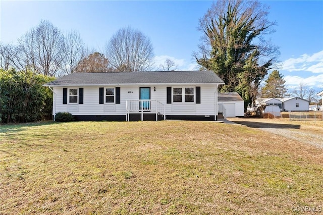 ranch-style home featuring an outbuilding and a front lawn