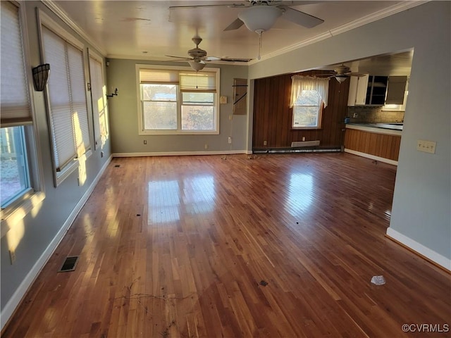 unfurnished living room with ceiling fan, crown molding, and dark hardwood / wood-style floors