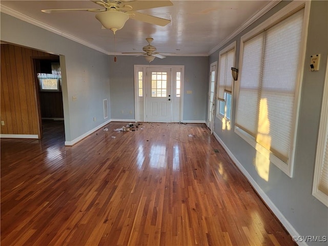 empty room featuring wood-type flooring and ornamental molding