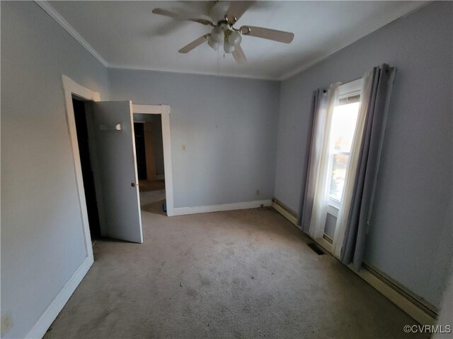 carpeted empty room with ornamental molding and ceiling fan