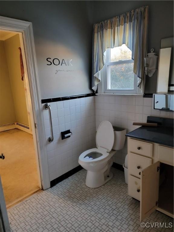 bathroom featuring tile patterned flooring, vanity, tile walls, and toilet