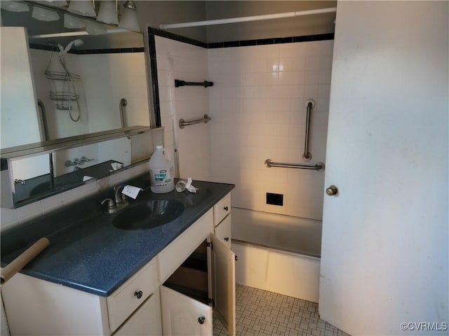 bathroom with vanity and tiled shower / bath combo