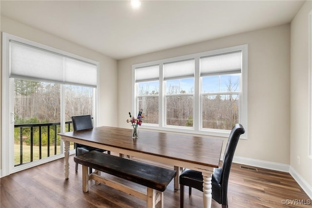 dining space with hardwood / wood-style floors