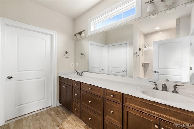 bathroom with vanity, a shower, and hardwood / wood-style floors