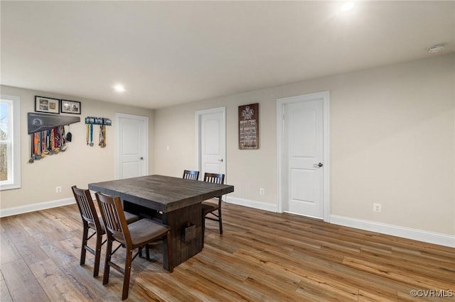 dining space with light hardwood / wood-style flooring