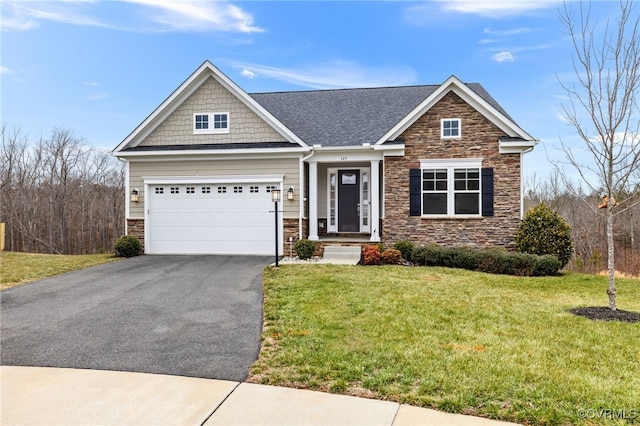 craftsman inspired home with a garage and a front yard