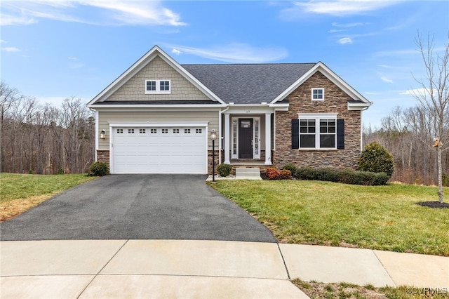 craftsman inspired home featuring a garage and a front yard