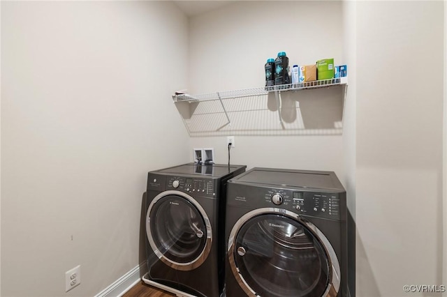 washroom with independent washer and dryer and wood-type flooring