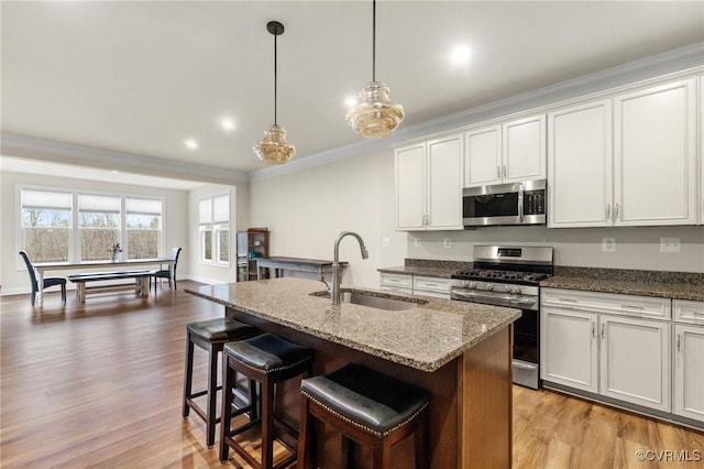 kitchen with white cabinetry and appliances with stainless steel finishes