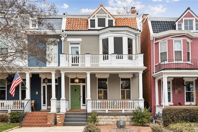 multi unit property featuring a porch and a balcony