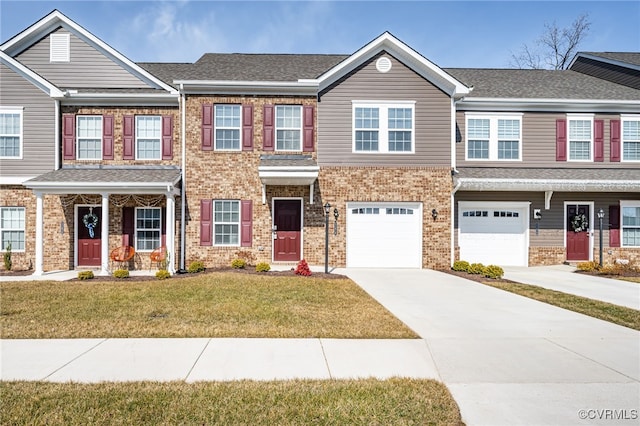 view of property with a garage and a front lawn