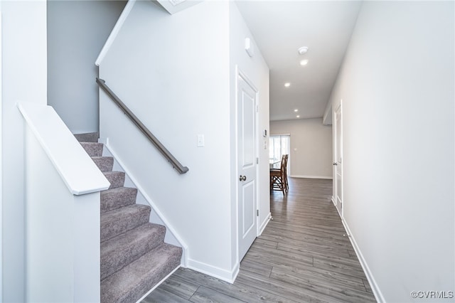 stairs with hardwood / wood-style floors