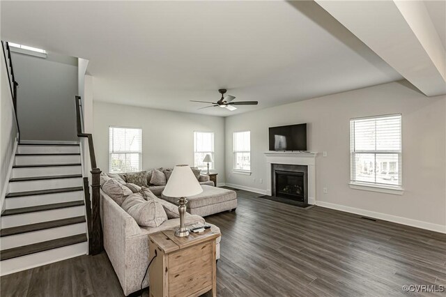 living room with dark hardwood / wood-style floors and ceiling fan