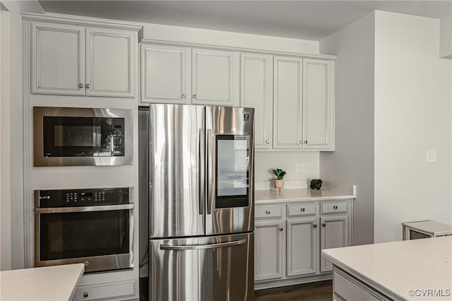 kitchen featuring stainless steel appliances and dark hardwood / wood-style floors