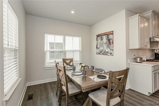 dining area featuring dark wood-type flooring