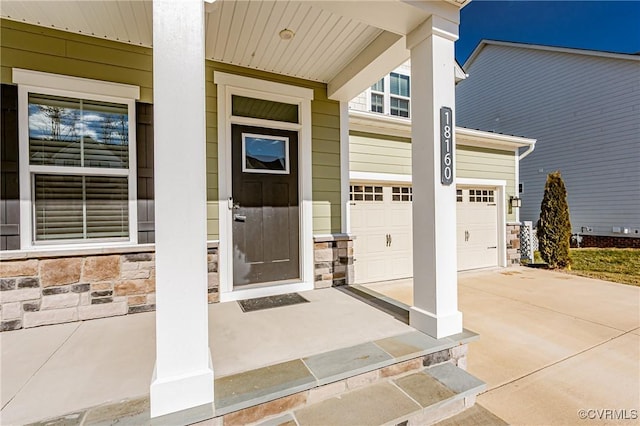 property entrance with a garage and covered porch