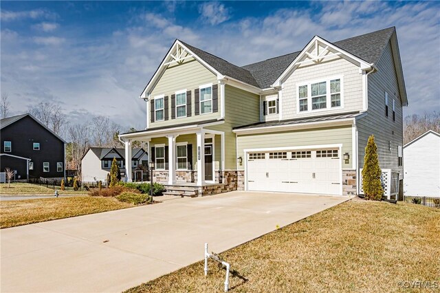 craftsman-style house featuring a porch, a garage, and a front lawn