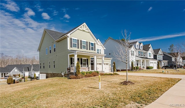 view of front facade featuring a garage, a front lawn, and a porch