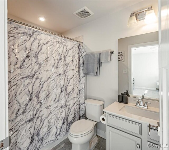 bathroom with vanity, toilet, and walk in shower