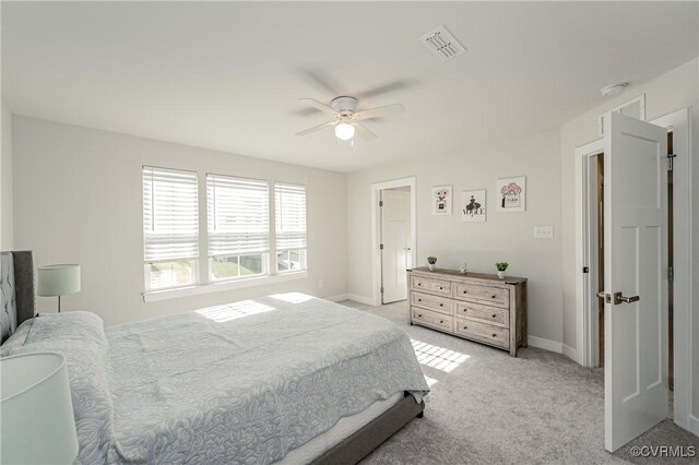 bedroom featuring ceiling fan and light carpet