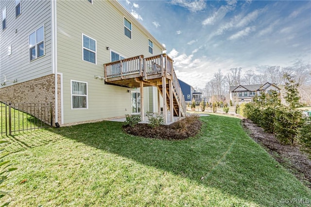 back of property featuring a lawn and a deck