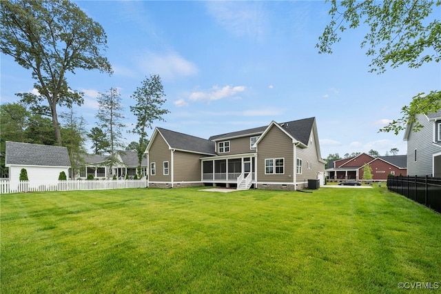 back of property featuring a sunroom and a yard