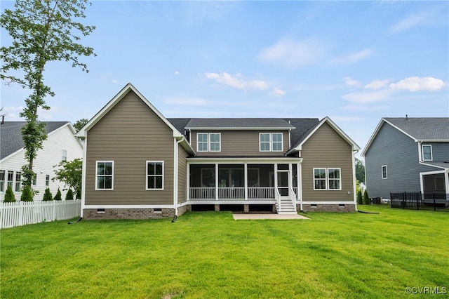 rear view of property with a sunroom and a yard