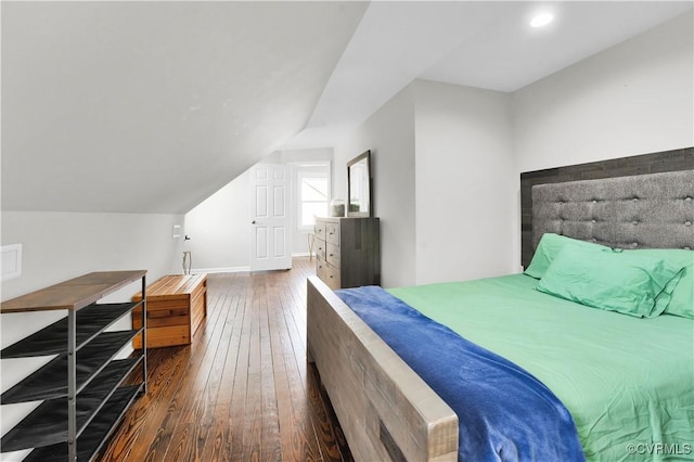 bedroom with vaulted ceiling and dark wood-type flooring