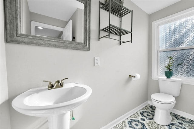 bathroom with sink, tile patterned floors, and toilet