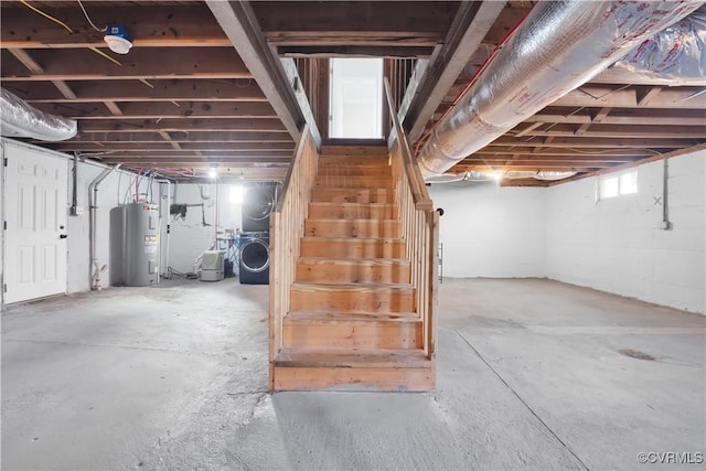 basement featuring washer and dryer and water heater