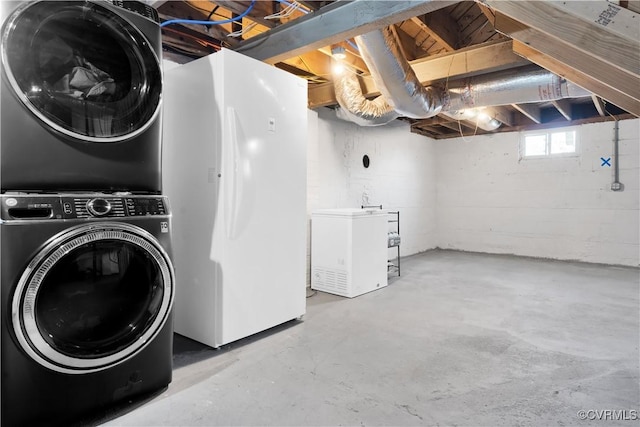 clothes washing area featuring stacked washer and clothes dryer