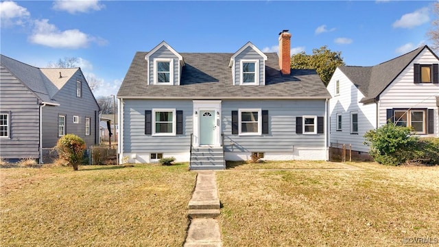 cape cod home featuring a front lawn