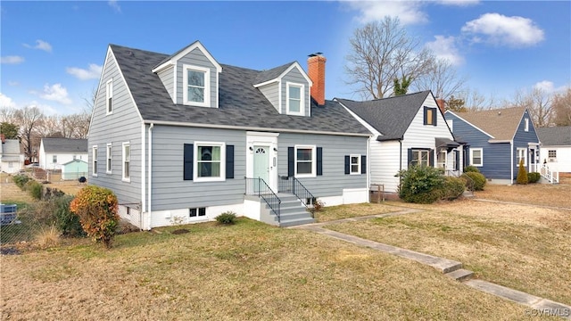 cape cod home with a front yard