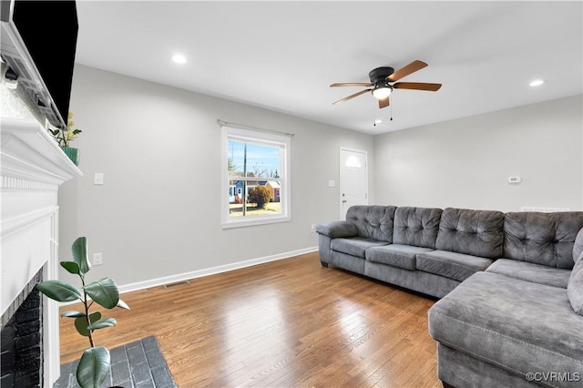 living room with ceiling fan and hardwood / wood-style floors