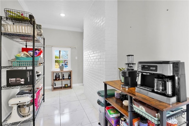 kitchen featuring ornamental molding and brick wall