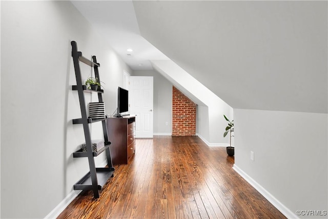 bonus room with lofted ceiling and dark wood-type flooring