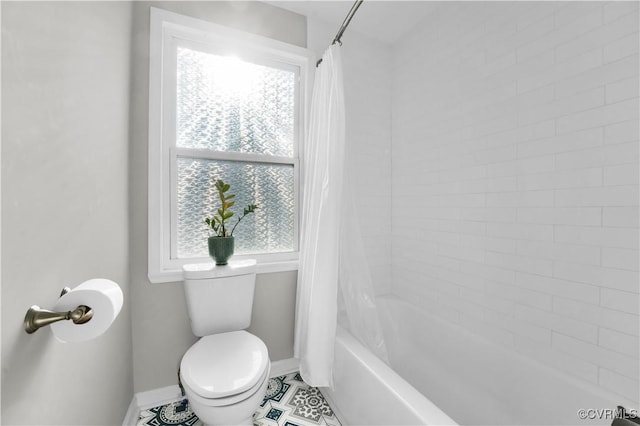 bathroom featuring shower / bathtub combination with curtain and toilet