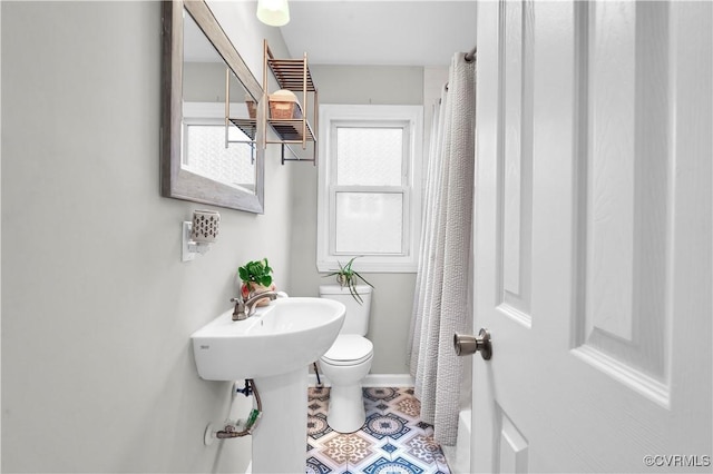 bathroom with tile patterned flooring and toilet