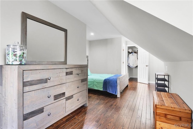 bedroom featuring vaulted ceiling and dark wood-type flooring