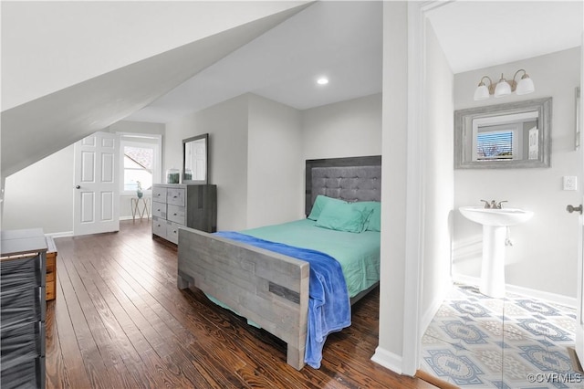 bedroom with lofted ceiling and dark hardwood / wood-style flooring